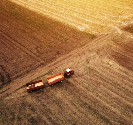Aerial view of agricultural tractor in the field